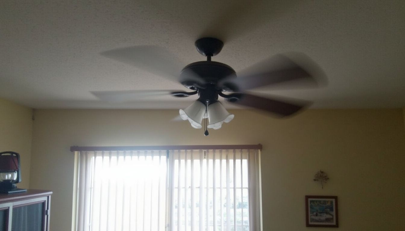 A cozy, lived-in room with a ceiling fan and gently swaying curtains, capturing an everyday moment.