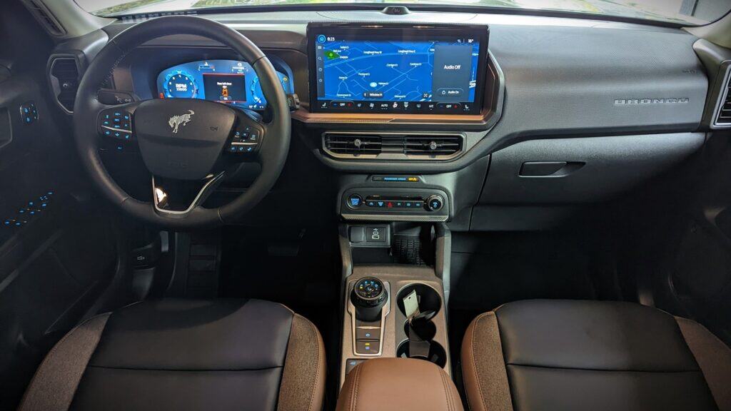 2025 Ford Bronco Sport Outer Banks Review 5 High-tech vehicle dashboard with digital instrument cluster, touchscreen infotainment system, and modern controls inside a Ford Bronco for an advanced driving experience.