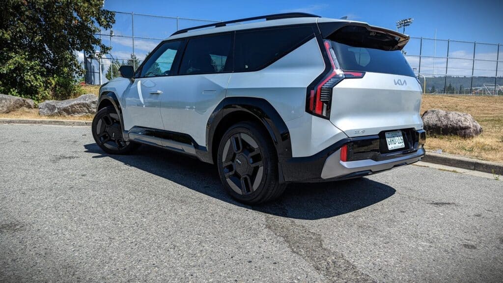 2025 Kia EV9 GT-Line Review 5 Futuristic silver Kia EV6 electric SUV parked outdoors on a sunny day.