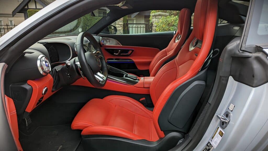 2025 Mercedes-AMG GT 63 4MATIC+ Coupe Review 14 Luxurious red leather sports car interior with high-performance seats, advanced dashboard, and sleek controls, designed for driving enthusiasts and luxury automobile lovers.