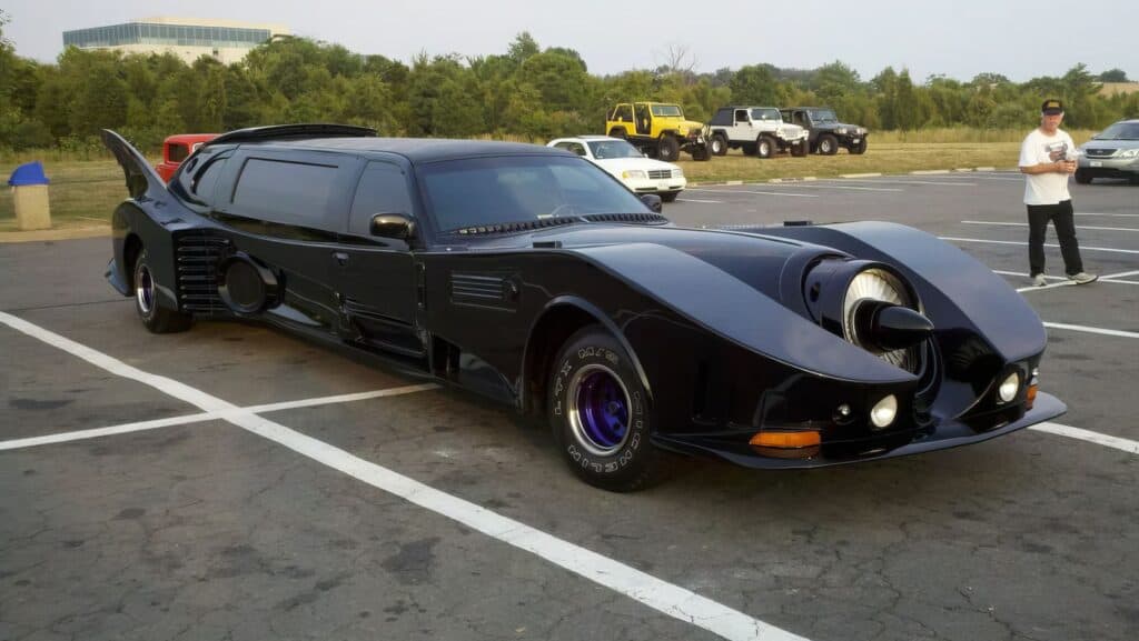 The $4 Million Batmobile Limousine: A Recreation of One of the Most Recognized Cars in the World 2 Custom Black Batmobile car with unique design, parked in an outdoor lot, showcasing a futuristic sports car look for automotive enthusiasts.