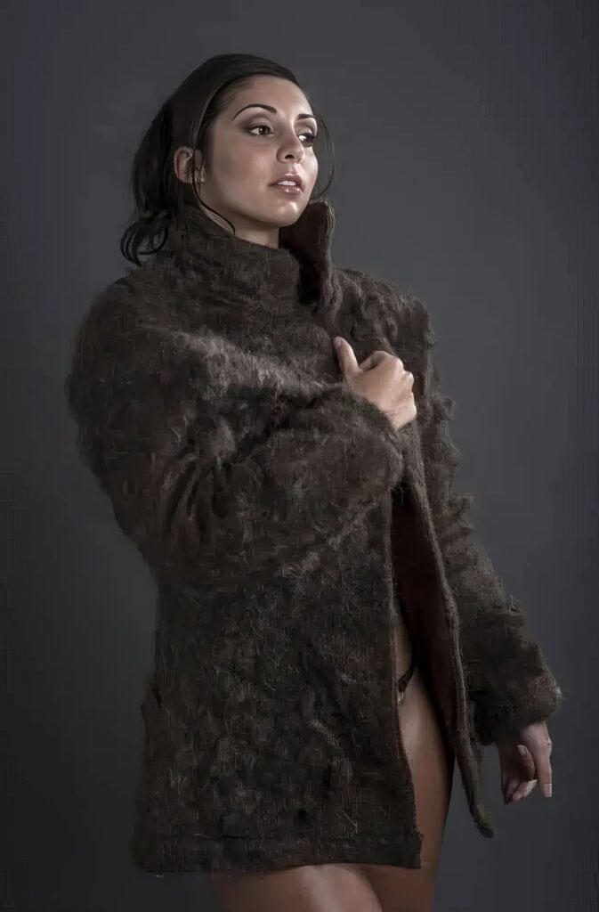 Chest Hair Fur Coat: The Quirky Design That's Turning Heads 2 A confident woman in a textured brown coat with a dark background.