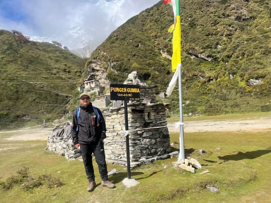 How Difficult Is Manaslu Trek? Challenges & Tips 6 Hiking man at Pungent Gumba mountain peak in Nepal, outdoor adventure, trekking and mountain exploration in Himalayas.