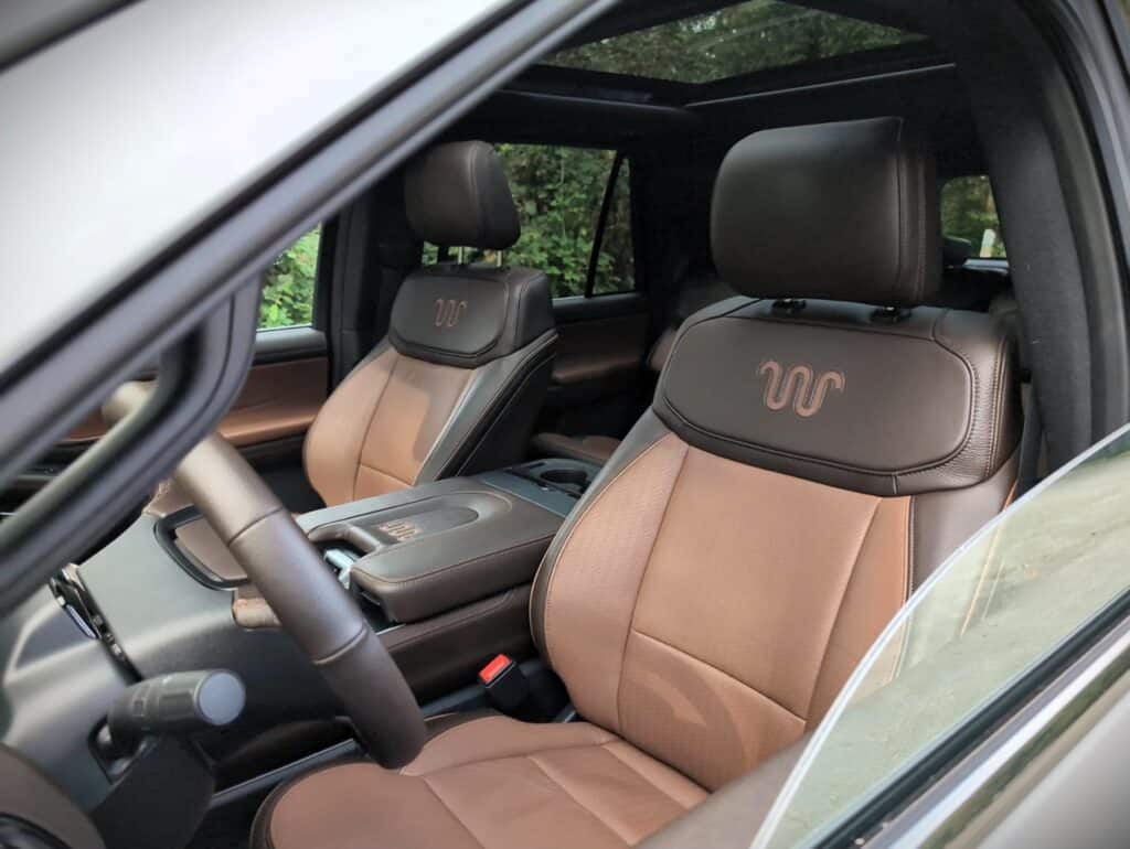 2025 Ford Expedition King Ranch Review 13 Luxurious brown leather car seats with detailed stitching and embroidered logos, highlighting premium automotive interior and comfort features.