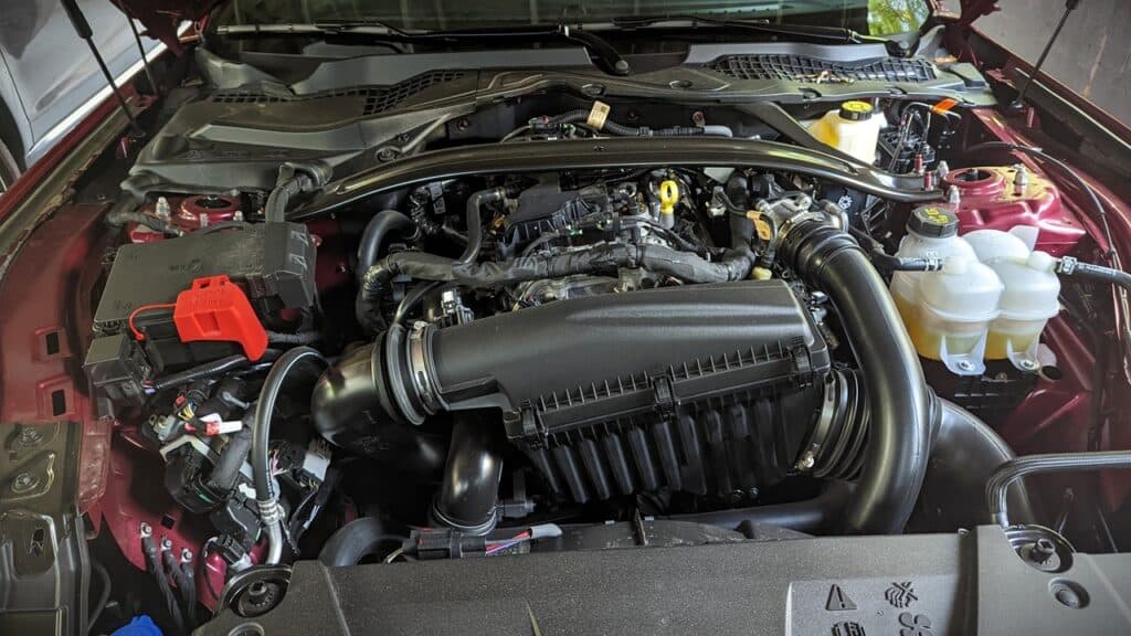 2025 Ford Mustang EcoBoost Premium Convertible Review 2 Car engine under hood, high-performance engine with visible components, suitable for automotive enthusiasts and car maintenance.