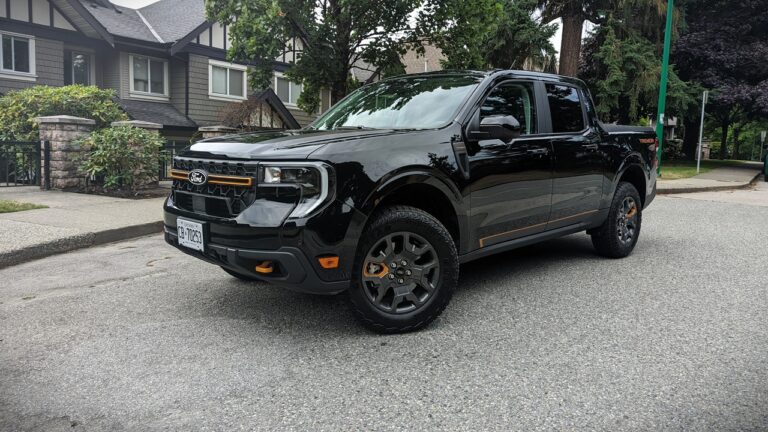 Black Ford Ranger truck, rugged off-road pickup, modern design with orange accents, ideal for outdoor adventures and daily driving in a suburban neighborhood.