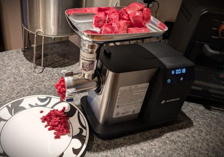 High-quality electric meat grinder with stainless steel blades for homemade beef and meat preparation.