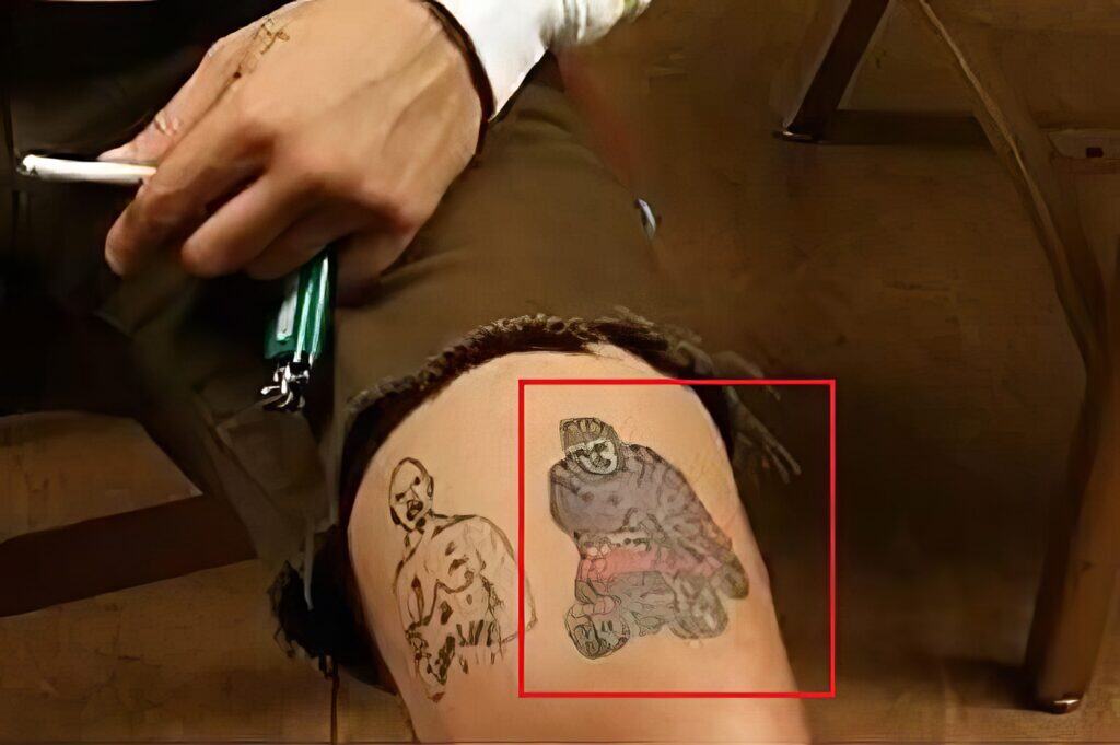 A man with a Joker and clown tattoo on his thigh, showcasing creative and bold body art designs, perfect for men's tattoo inspiration and design ideas.