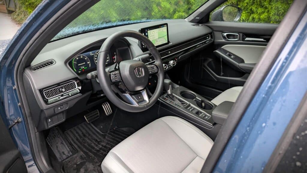 High-quality image showing the interior of a Honda vehicle with modern features, steering wheel, dashboard, and navigation screen, highlighting luxury and advanced automotive technology.