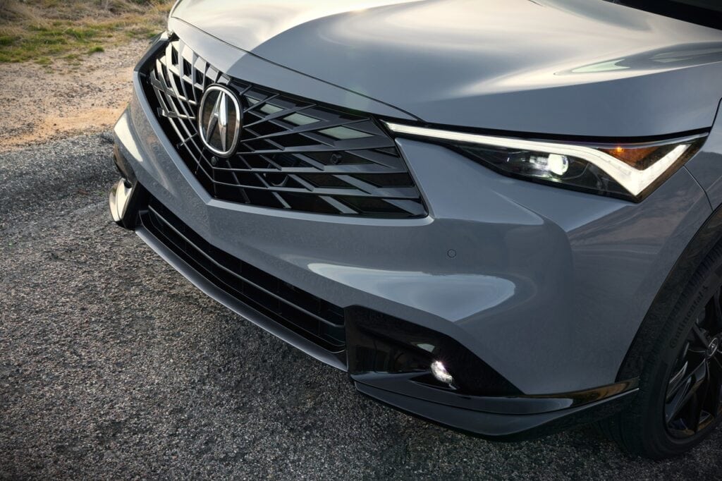Close-up of the front grille and headlight design of the 2026 Acura ADX Platinum Elite A-Spec, showcasing modern automotive styling and premium features.