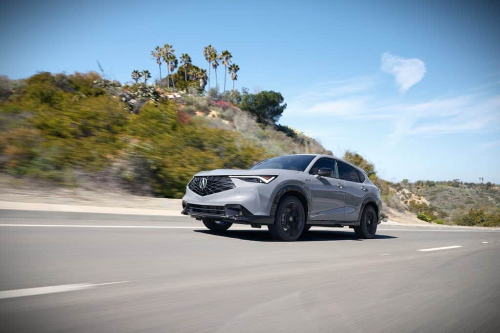 Elegant 2026 Acura ADX Platinum Elite A-Spec driving on open highway.