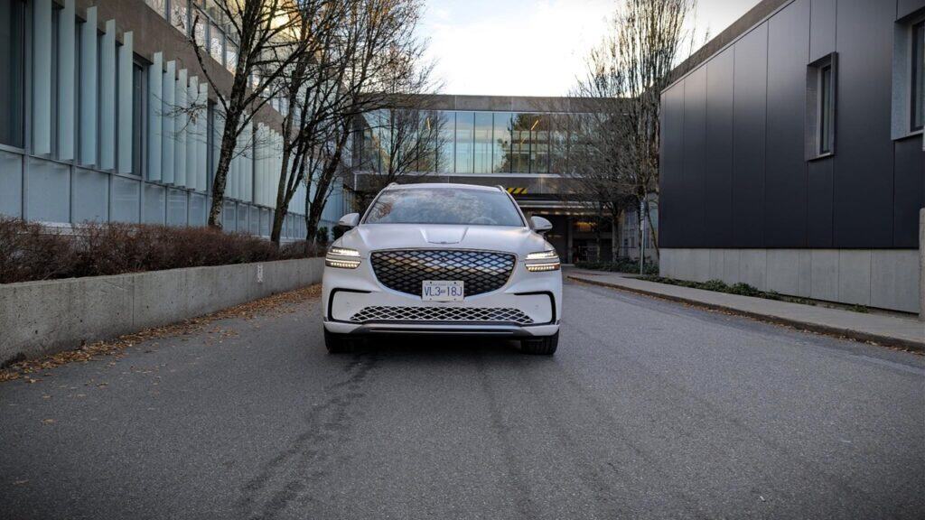 Elegant white 2026 Genesis Electrified GV70 parked on a city street.