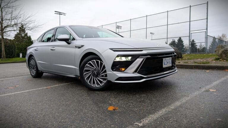 Modern Hyundai Sonata Hybrid parked on a wet outdoor court.