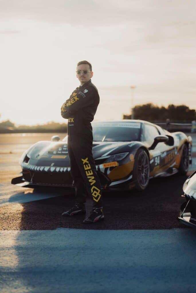 Carl Moon Runefelt standing confidently next to his Ferrari race car at Paul Ricard during the Ferrari Challenge debut.