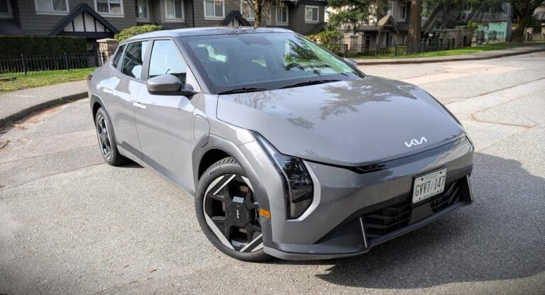 EV4 Kia electric vehicle parked on street with modern design and sleek gray exterior.