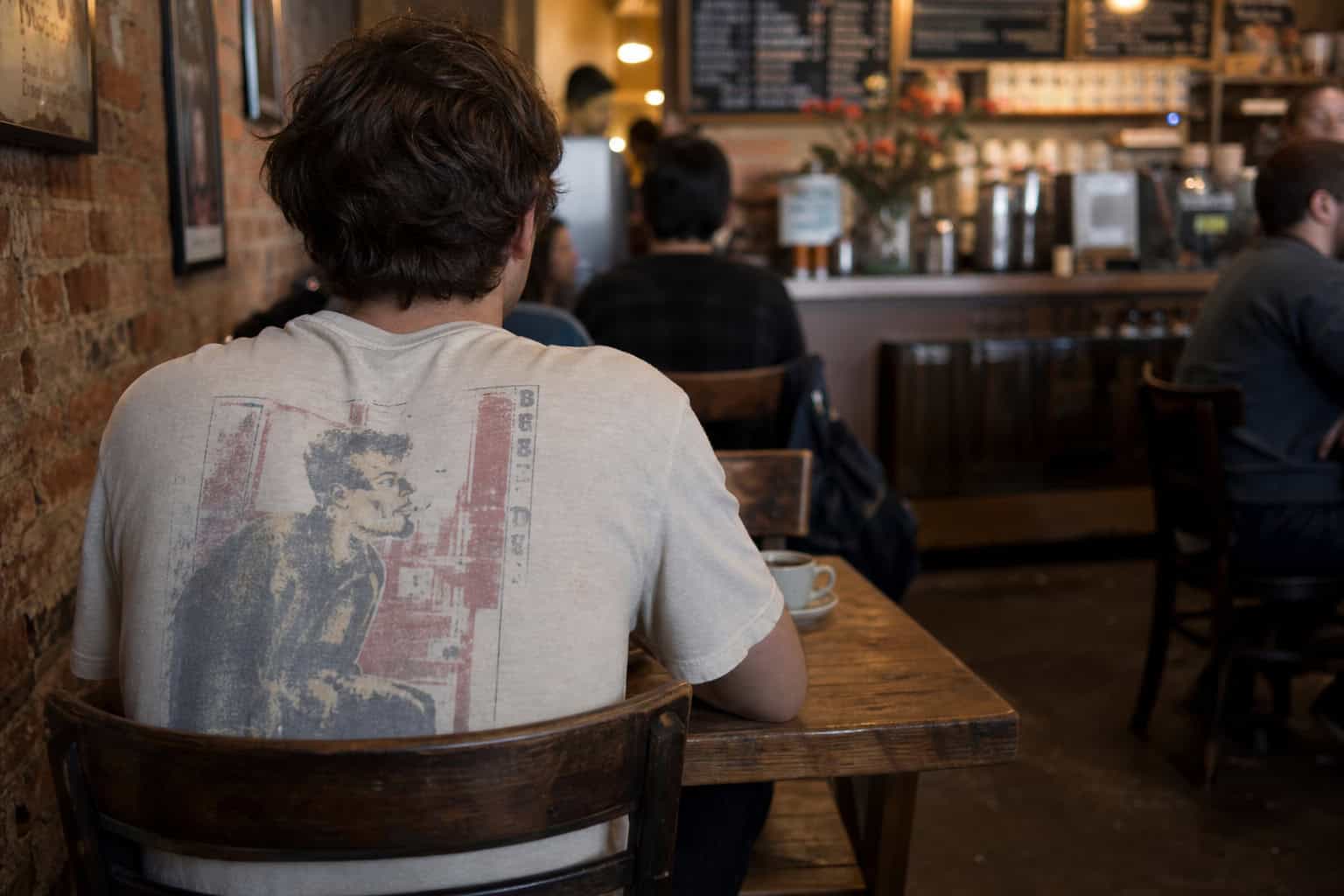 Wearing a graphic t-shirt to maintain visual camouflage in public settings.