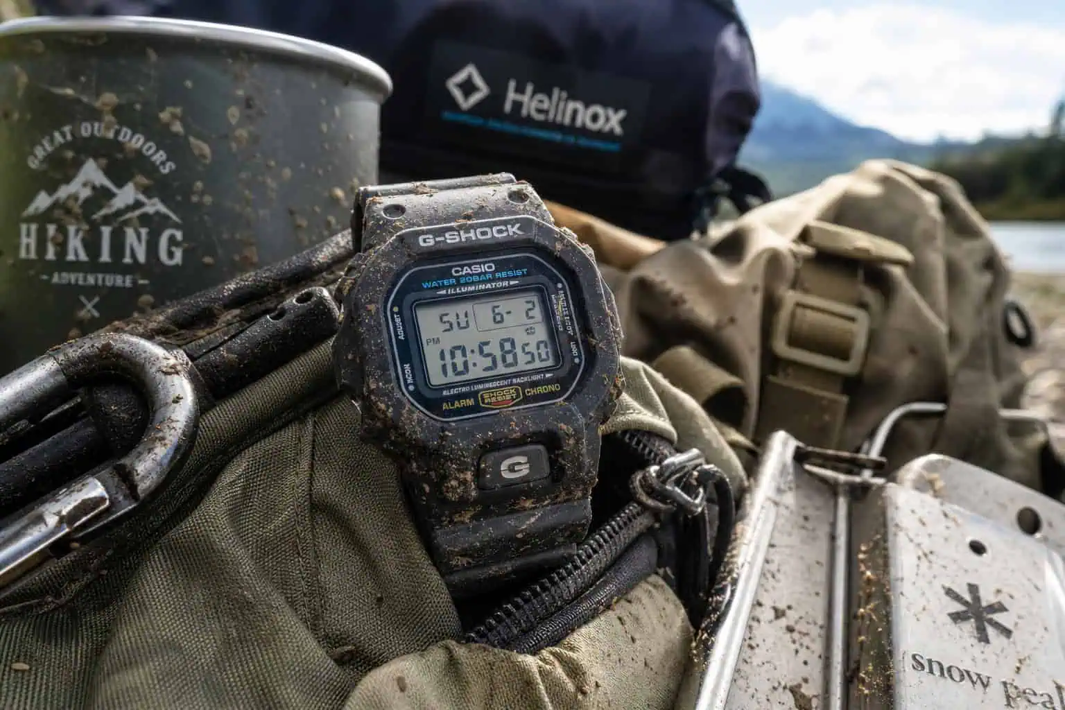 Mud-splattered G-Shock watch on camping gear, representing a durable daily beater watch.