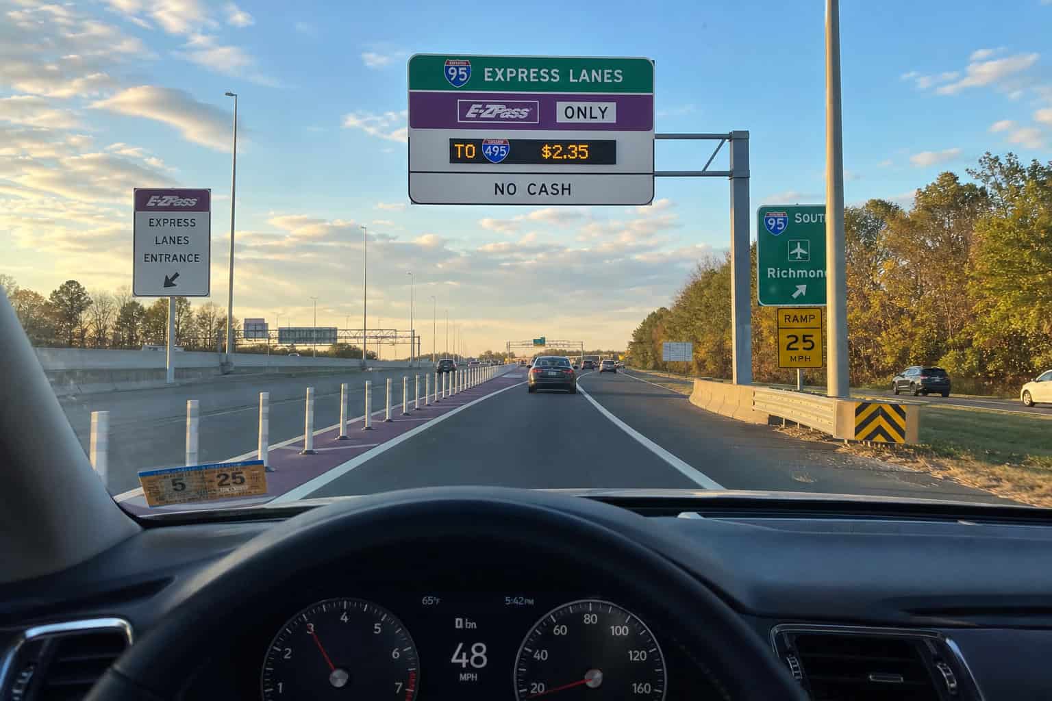 Driver's view of I-95 Express Lane entrance with plastic poles and signage.