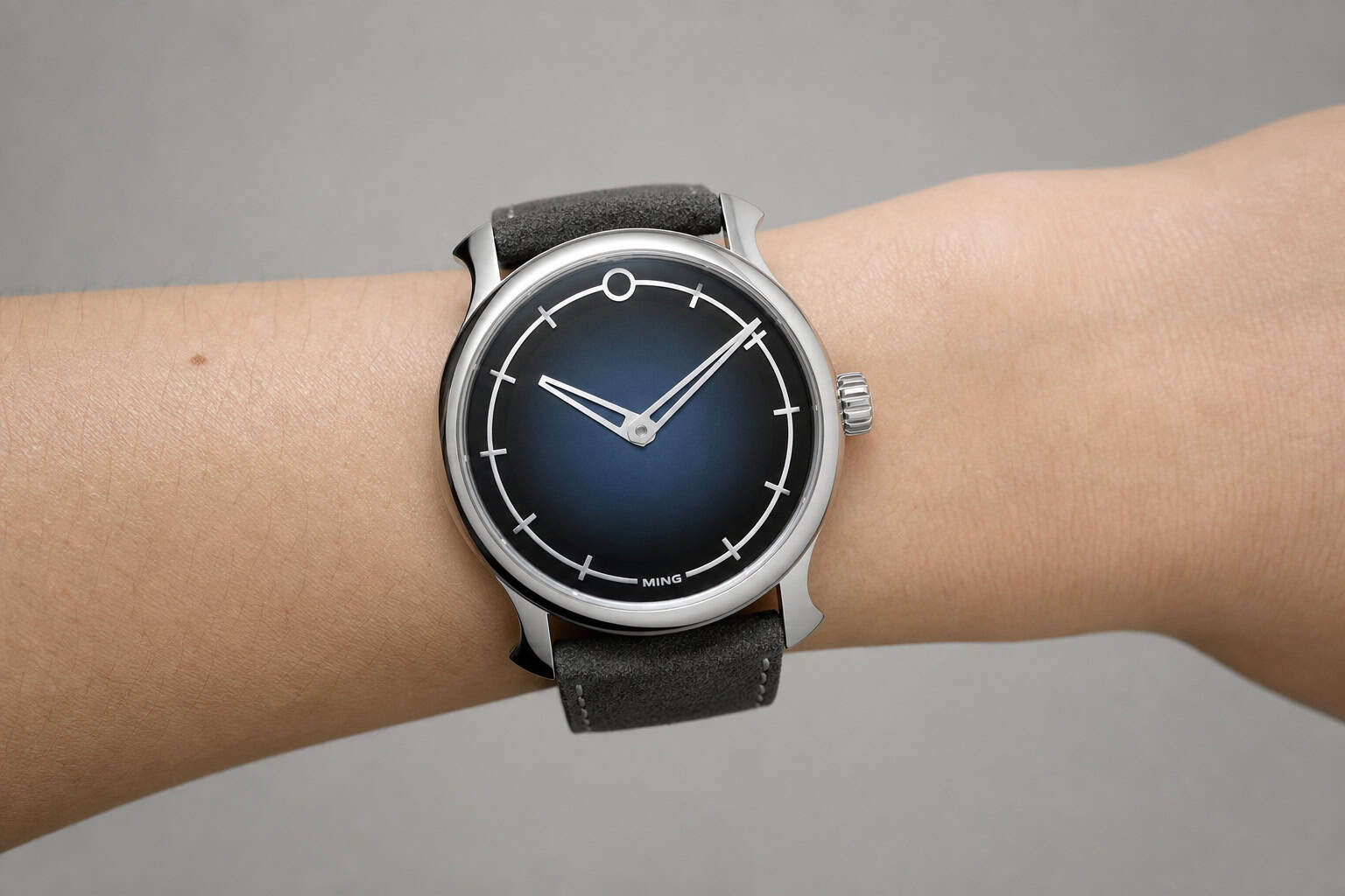 Close-up of Ming watch on small wrist with long lugs overhanging, illustrating sizing error.