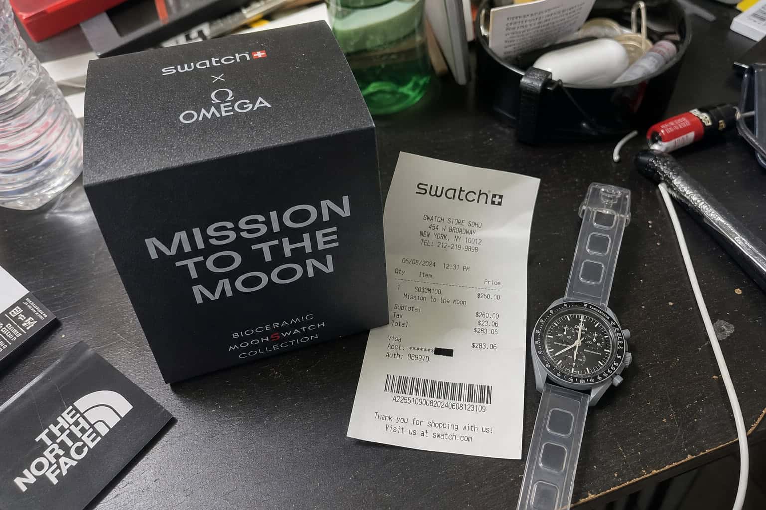 Swatch MoonSwatch box and receipt on a cluttered desk, illustrating impulse buying regret.