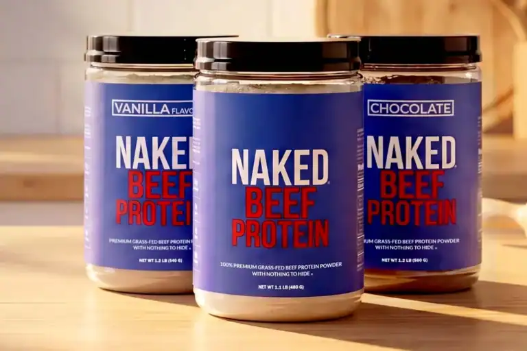 Three containers of Naked Beef Protein powder in vanilla and chocolate flavors on a wooden surface, showcasing the product packaging.