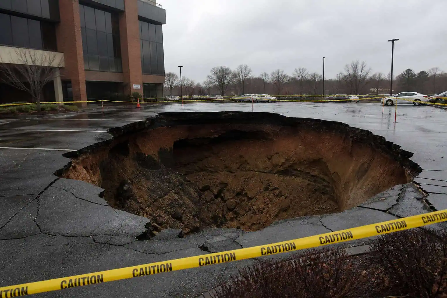 Sinkhole in Allentown parking lot illustrating hidden damage beneath surface, like an affair.