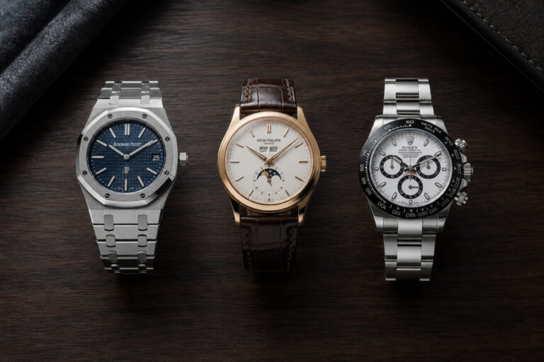 Three luxury wristwatches displayed on a dark wooden surface, showcasing different styles and features for men's fashion and accessories.