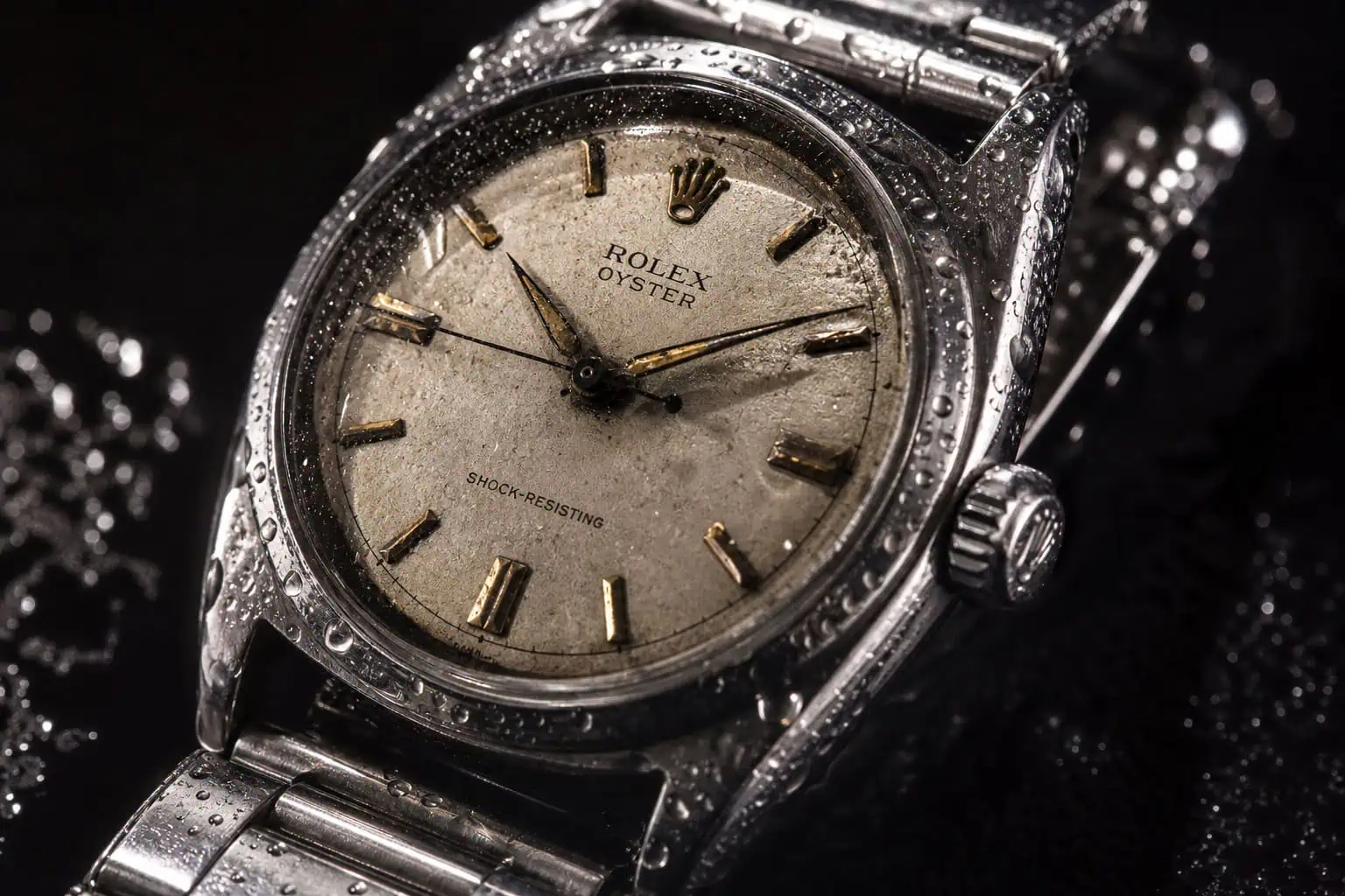 Omega vs Rolex History: 176 Years of Rivalry From NASA to Everest 4 Rolex Oyster case from 1926 the first waterproof watch in action with water splashes.