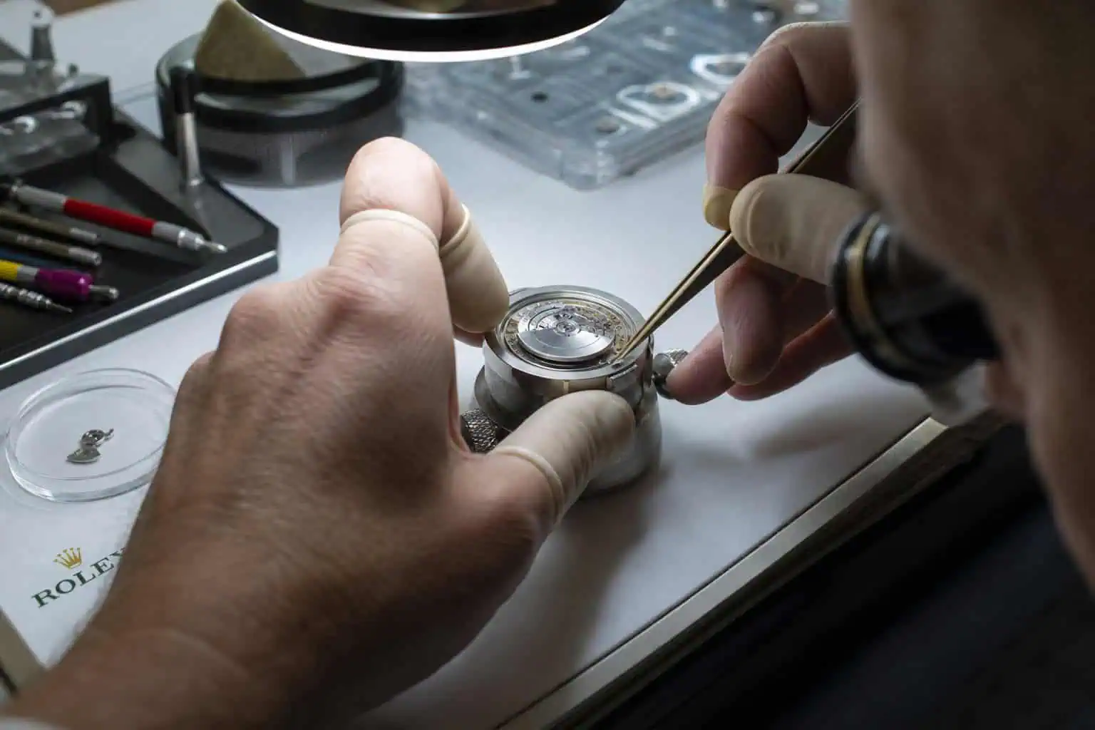 Omega vs Rolex Durability: Which Watch Can Take a Beating? 5 Watchmaker servicing a Rolex movement for long-term ownership and serviceability