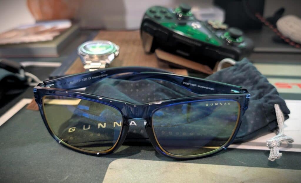 GUNNAR Intercept Review: Crystal Cobalt Owner on Fit, Lenses, and Real Eye Strain Relief 2 Gunnar Intercept sunglasses with blue frames and tinted lenses on a cluttered desk.