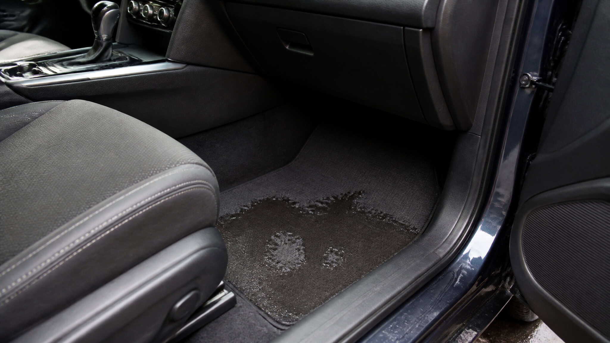 AC Leaking Water? Here's How to Diagnose and Fix It (Step-by-Step Guide) 3 Water puddle on car floorboard from AC leak