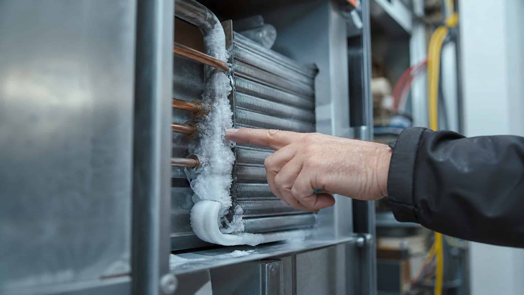 AC Blowing Warm Air? 6 Causes and the 90% Outdoor Unit Rule 2 Frozen evaporator coil inside an air handler, a sign of airflow or refrigerant problems.