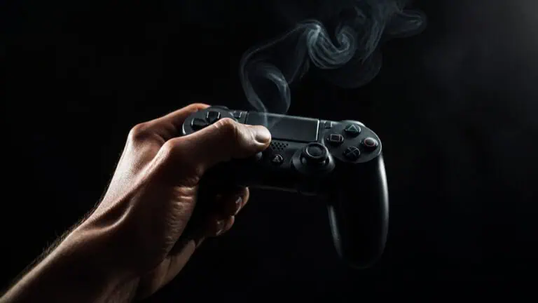 Close-up of a hand holding a gaming controller with smoke rising in a dark background, emphasizing gaming and entertainment themes.