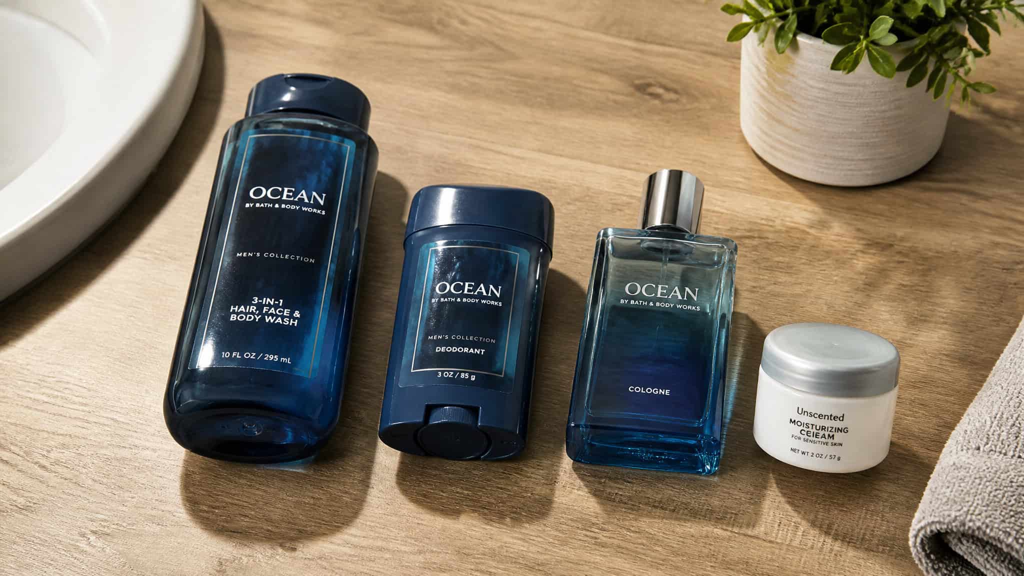 Smellmaxxing Reddit: The Megamind Meme, the Routine, and the Scent Rotation 2 Set of Ocean men's grooming products including body wash, deodorant, cologne, and moisturizer on a wooden surface with a plant and towel nearby.