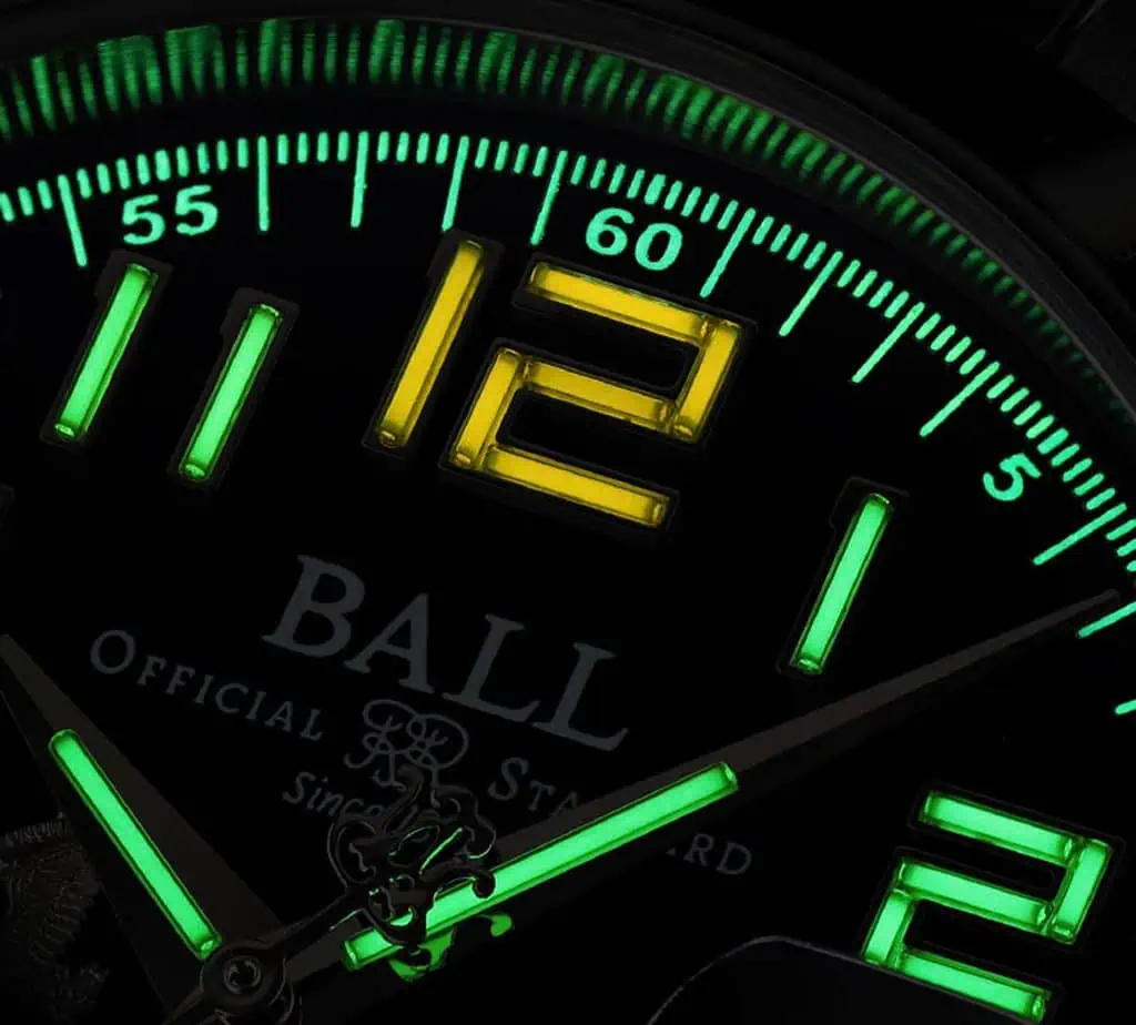 BALL Watch Engineer III Army: How the Four Versions Really Differ 4 Close-up of a BALL Engineer III Army watch dial with luminous green and yellow markers and hands, showcasing its precision and durability.