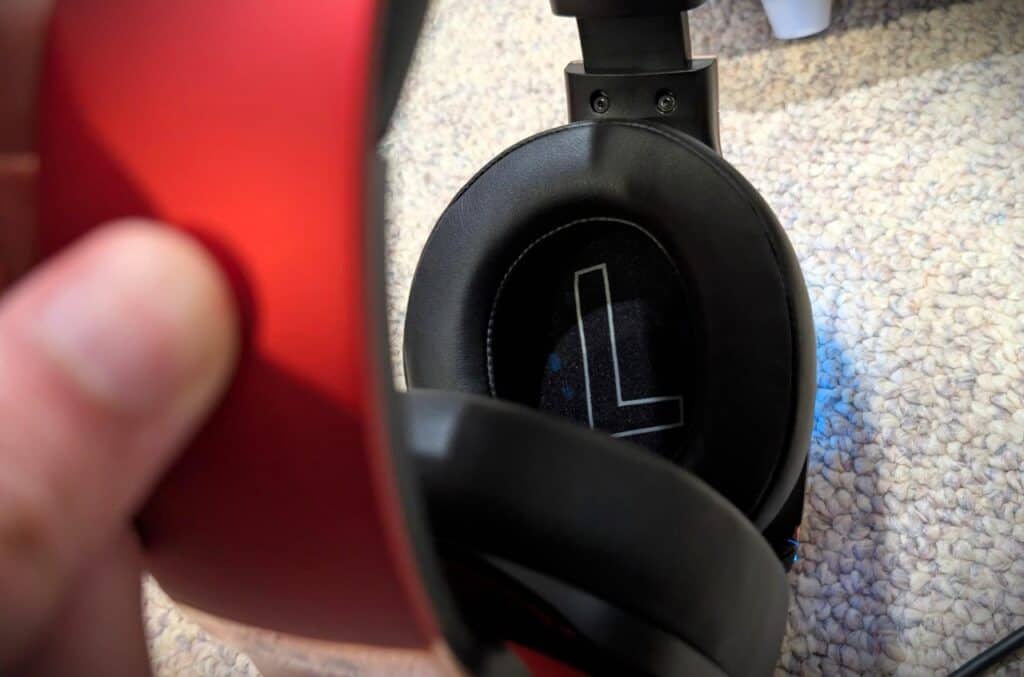 Edifier GX Professional Gaming Headset Review: Fortnite Nights With My Son Settled It 4 Close-up of black over-ear gaming headset with red earcup on a textured carpet floor.