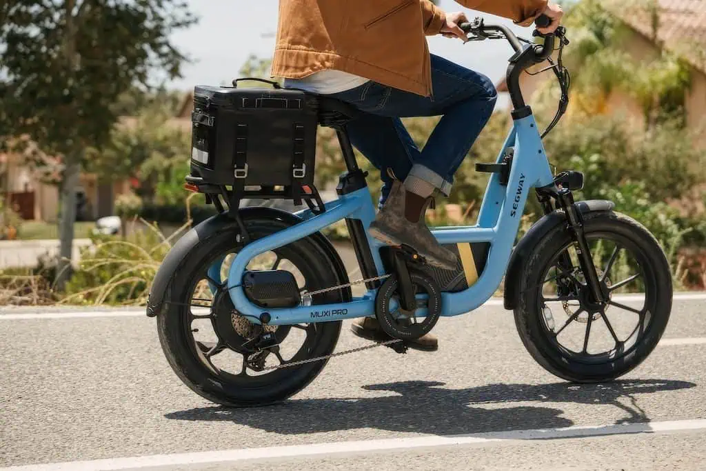 Segway MUXI Pro Cargo e-Bike: Full Specs, $1,999.99 Price, and the Fine Print 3 Unfinished Man Segway MUXI Pro cargo e-bike with a person riding on a suburban street.