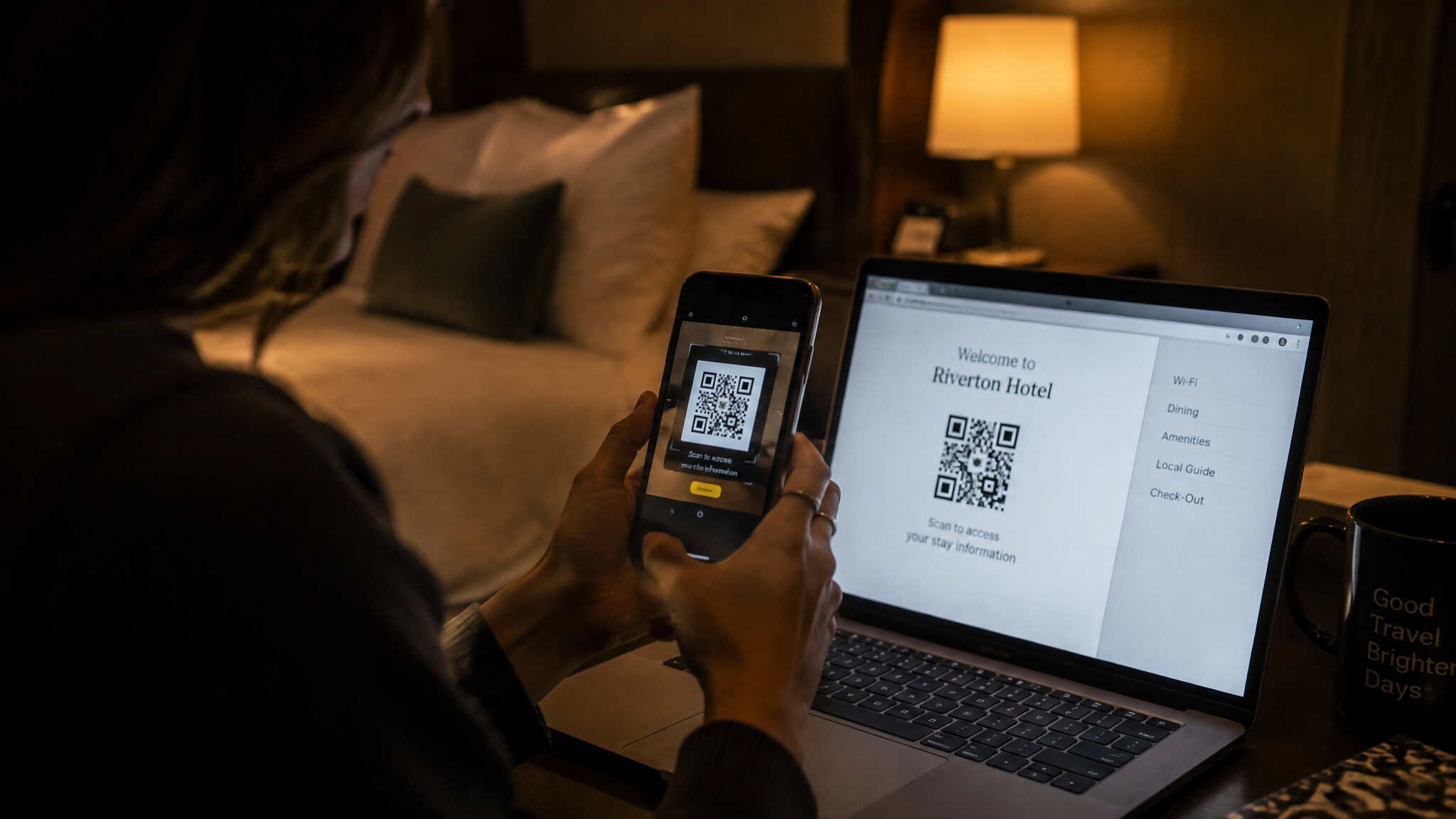 eSIM Not Working Abroad: Troubleshooting Guide — What to Fix at 5, 30, and 60 Minutes 4 Person scanning a QR code on a smartphone at Riverton Hotel reception with a laptop displaying the same QR code in a cozy hotel room setting.
