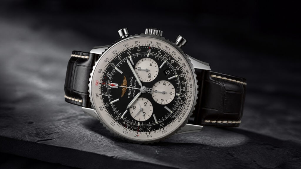 Close-up of a luxury men's chronograph watch with black dial, silver accents, and leather strap, showcasing precision and style.
