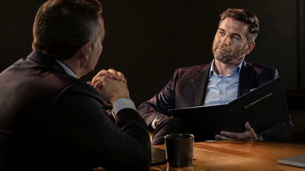 Two negotiators at a table illustrating negotiation skills and leverage for men