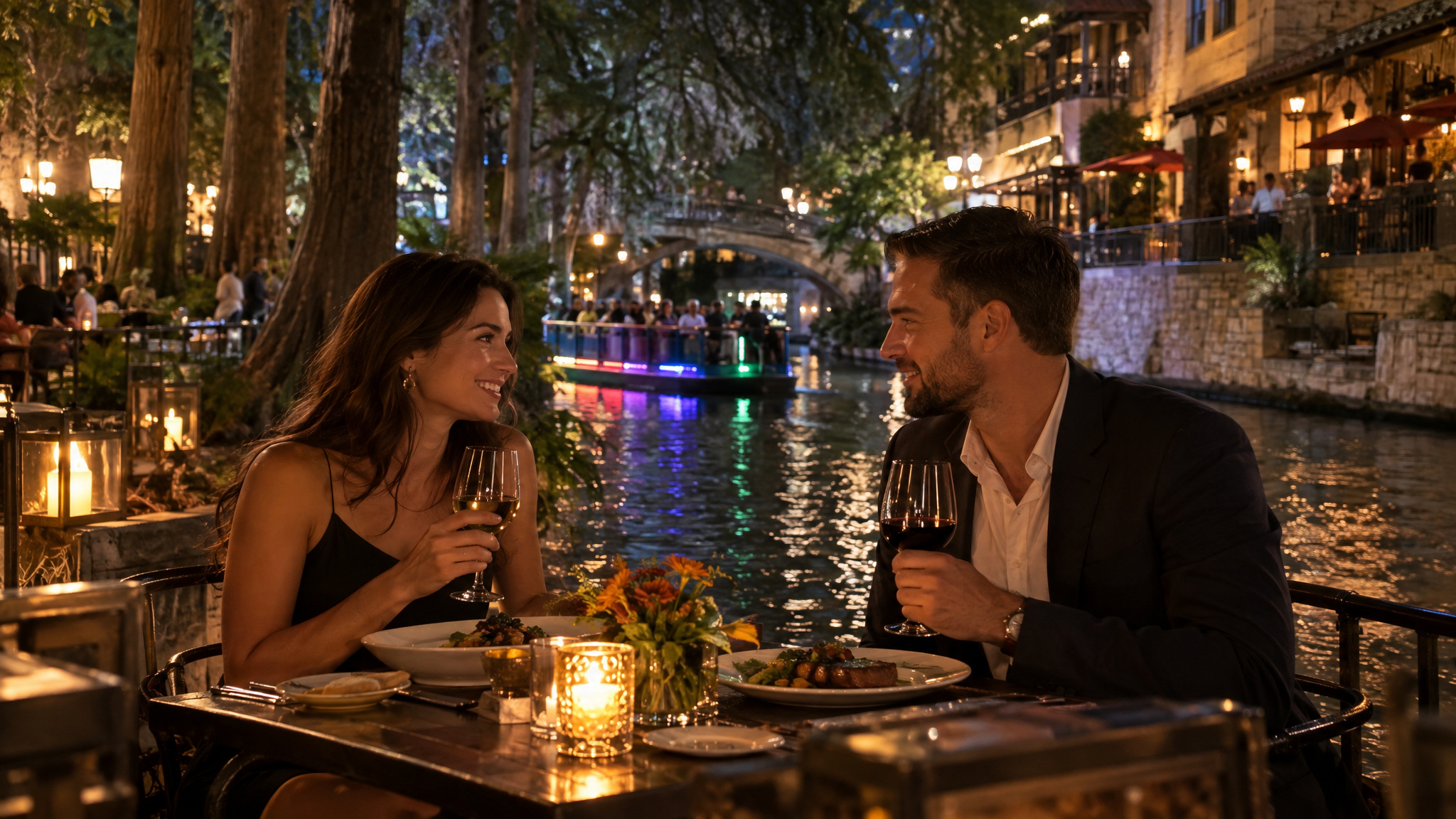 Couple enjoying riverside dinner at night on the San Antonio River Walk