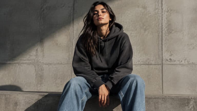 Streetwear audience represented by a young adult in a relaxed hoodie and denim