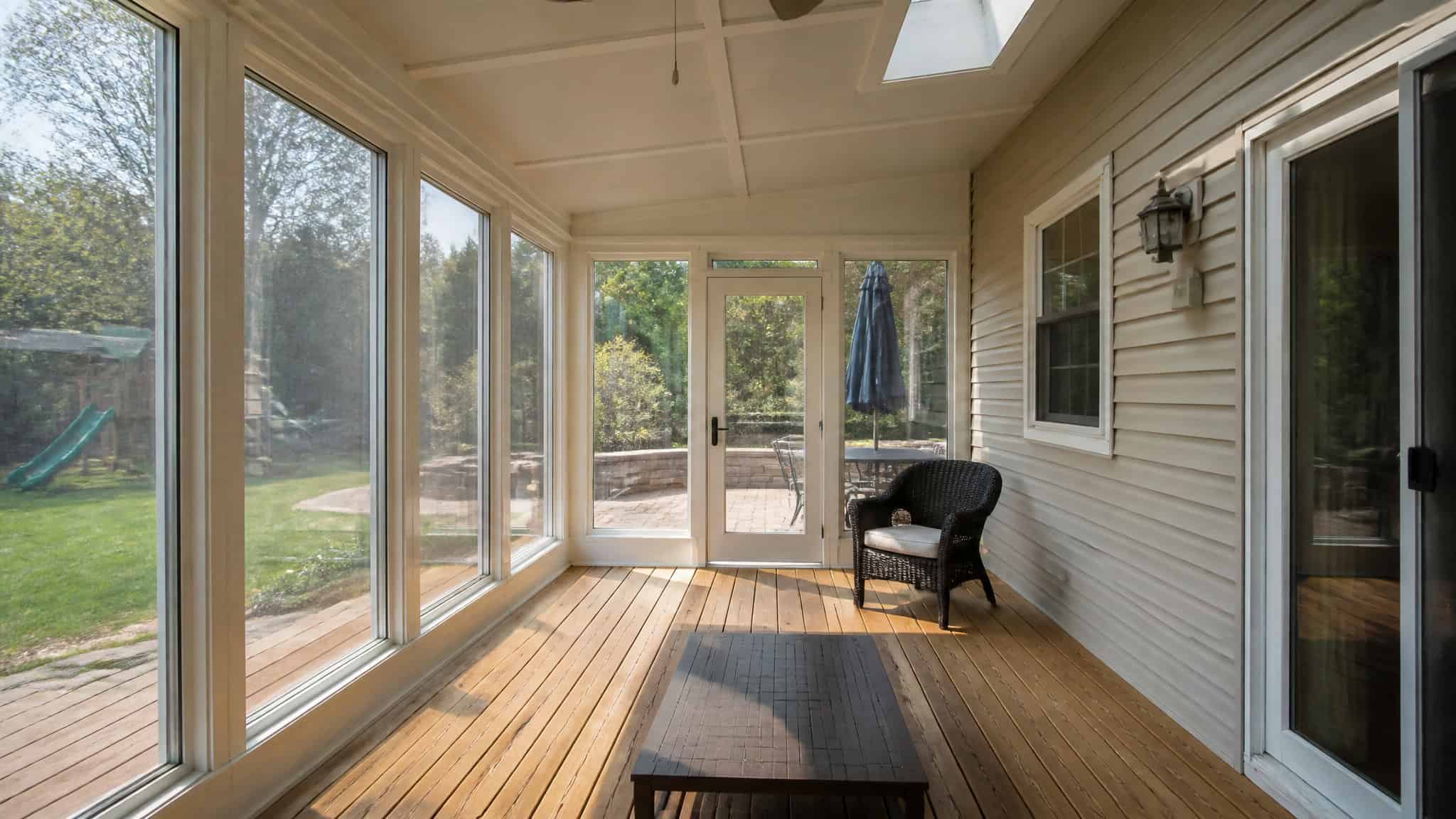 Worst ROI Home Improvements: 12 Renovations That Lose Money 4 Sunroom addition with large windows, illustrating how additions like this often return only half their cost.