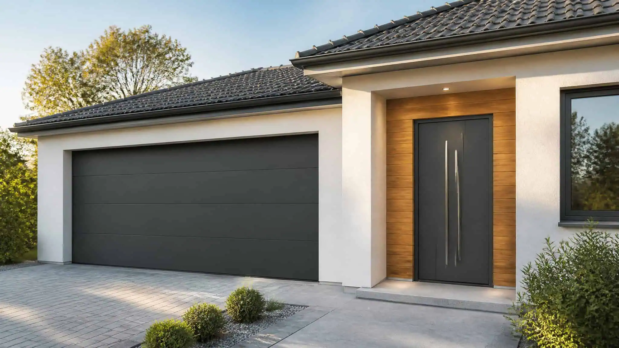 Contemporary house exterior featuring a large black garage door, a sleek front door, and modern design elements with natural landscaping.