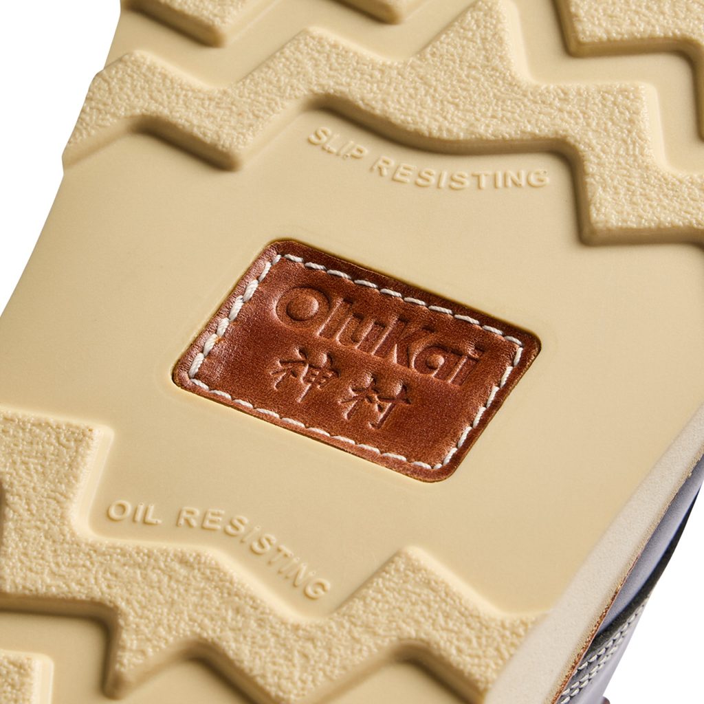 OluKai x Neil Kamimura Limited Edition 'Pāhi' Boots: Price, Release Date, and the Bladesmith Behind the Drop 4 Close-up of the sole of the OluKai x Neil Kamimura 'Pāhi' boots showing slip-resistant tread and leather logo detail.