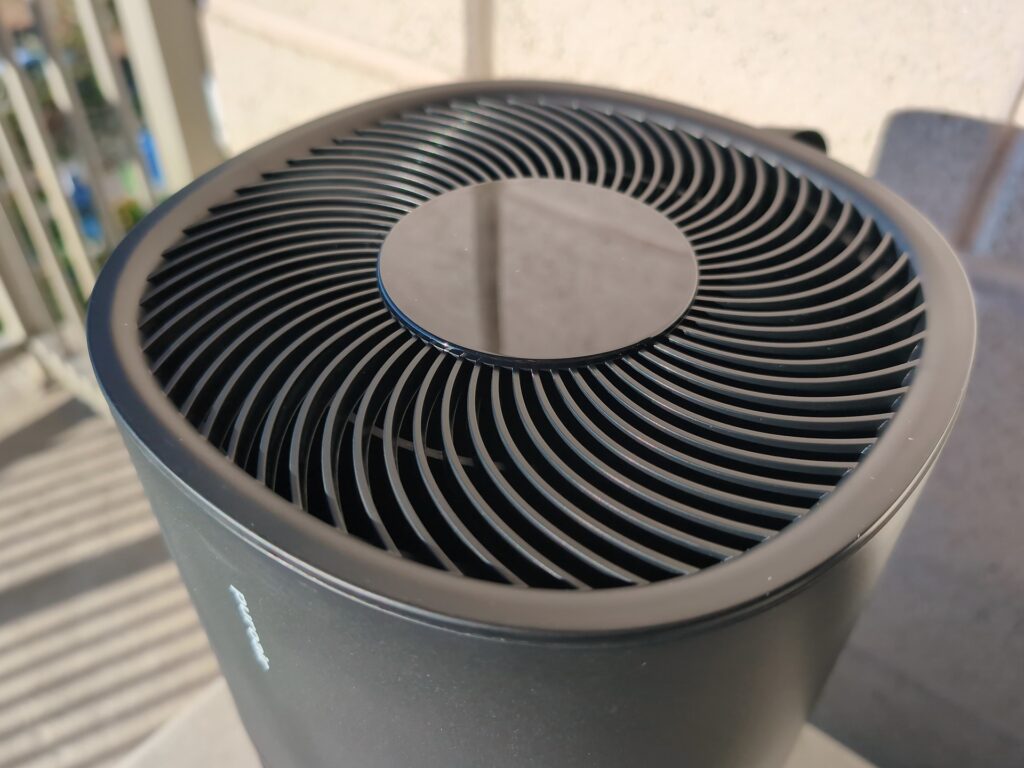 PuroAir 130i HEPA Smart Air Purifier Review: Why Its Real Room Size Is 116 Sq Ft, Not 600 2 Close-up of the PuroAir 130i HEPA Smart Air Purifier showing its circular air intake grille on a balcony.