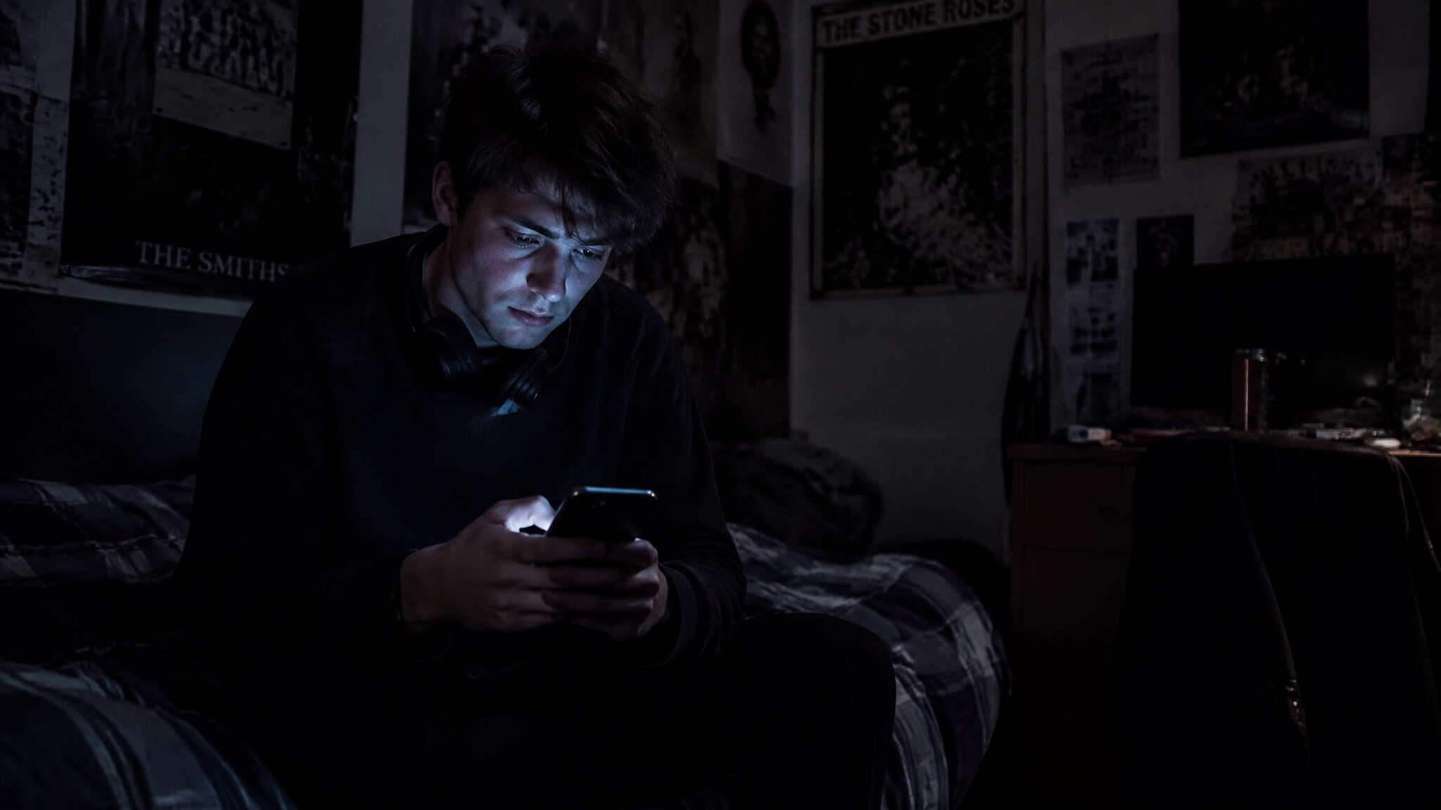 Why Do Men Not Want Relationships Anymore? The Data Says It's Hopelessness, Not Choice 3 Isolated young man alone with his phone at night, showing the manosphere pipeline feeding male hopelessness